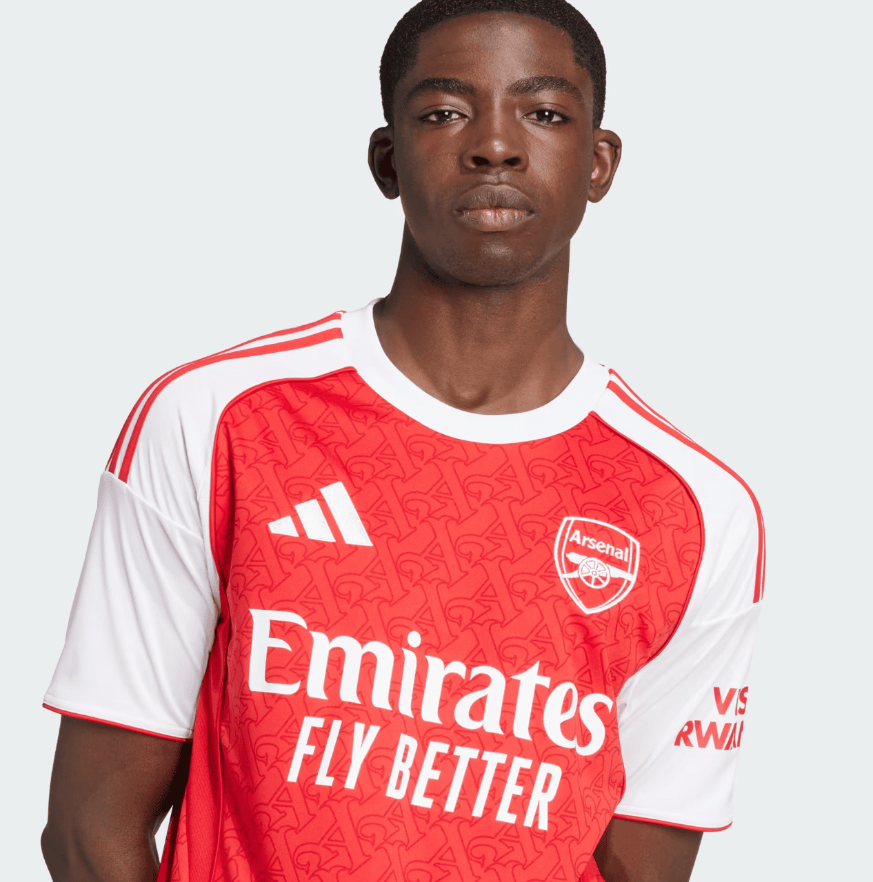 Screenshot2025-06-04185013 | AE JERSEY Portrait of a young man facing the camera, wearing a red and white Arsenal jersey with the Emirates Fly Better sponsor and crest visible.