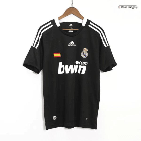 Black Real Madrid football jersey on a hanger with crest, Spanish flag patch, and bwin sponsor on the front.