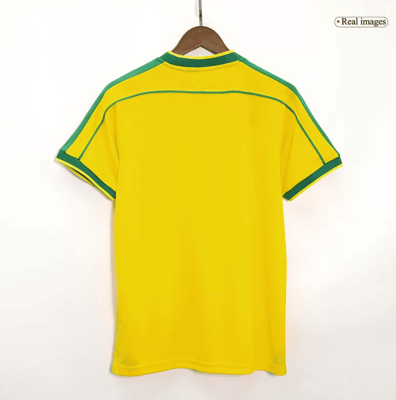 Screenshot_2024-07-20_032533 | AE JERSEY Back view of a bright yellow soccer jersey with green piping along shoulders and sleeves, on a wooden hanger