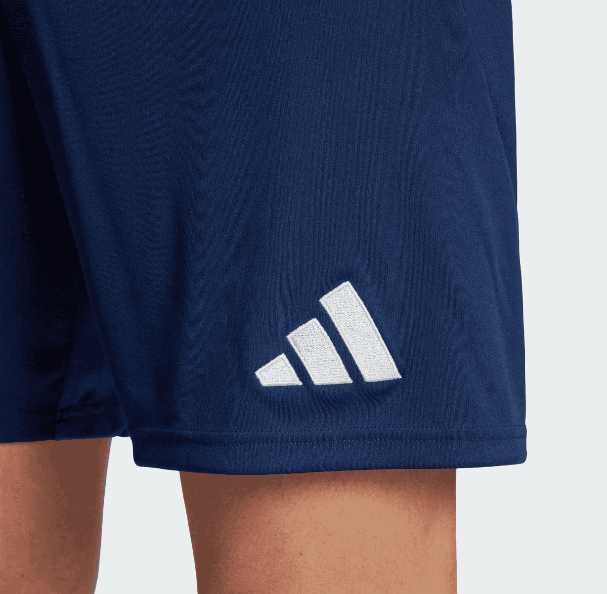 Screenshot_2024-09-18_222549 | AE JERSEY Close-up of navy athletic shorts hem with a white Adidas logo (three striped emblem).