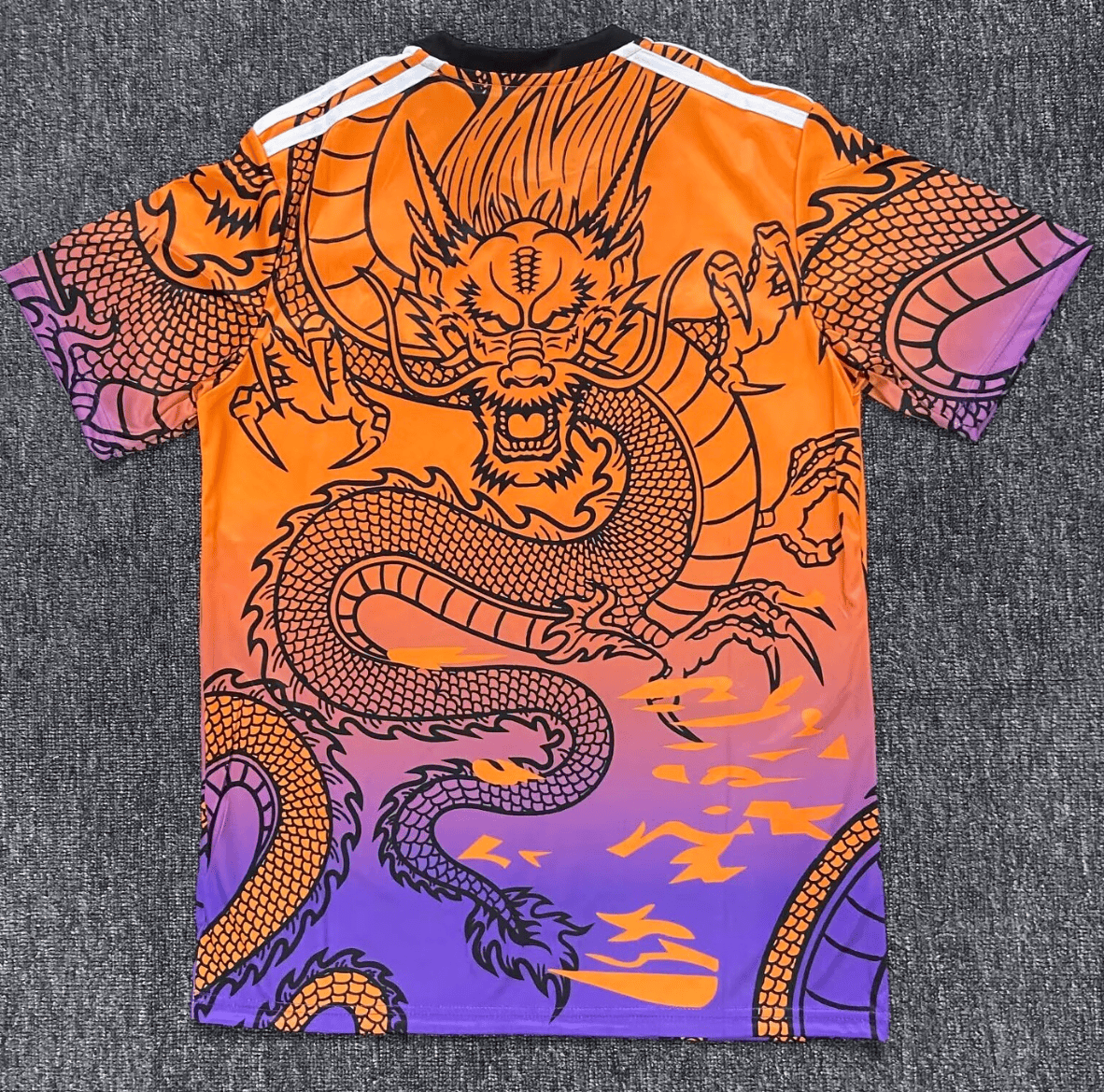Screenshot_2024-12-10_183810 | AE JERSEY Bright orange-to-purple graphic T-shirt featuring a bold black dragon design across the front and sleeves, in a mythic pose.