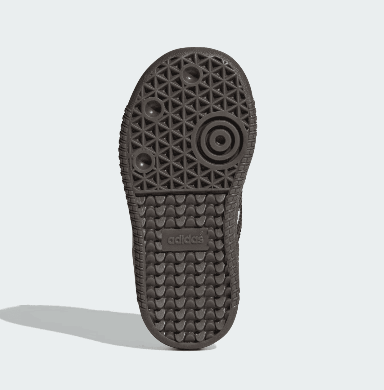 Screenshot_2025-02-10_201009 | AE JERSEY Bottom view of a dark brown Adidas sneaker sole with circular traction pattern and embossed Adidas logo near the arch area.