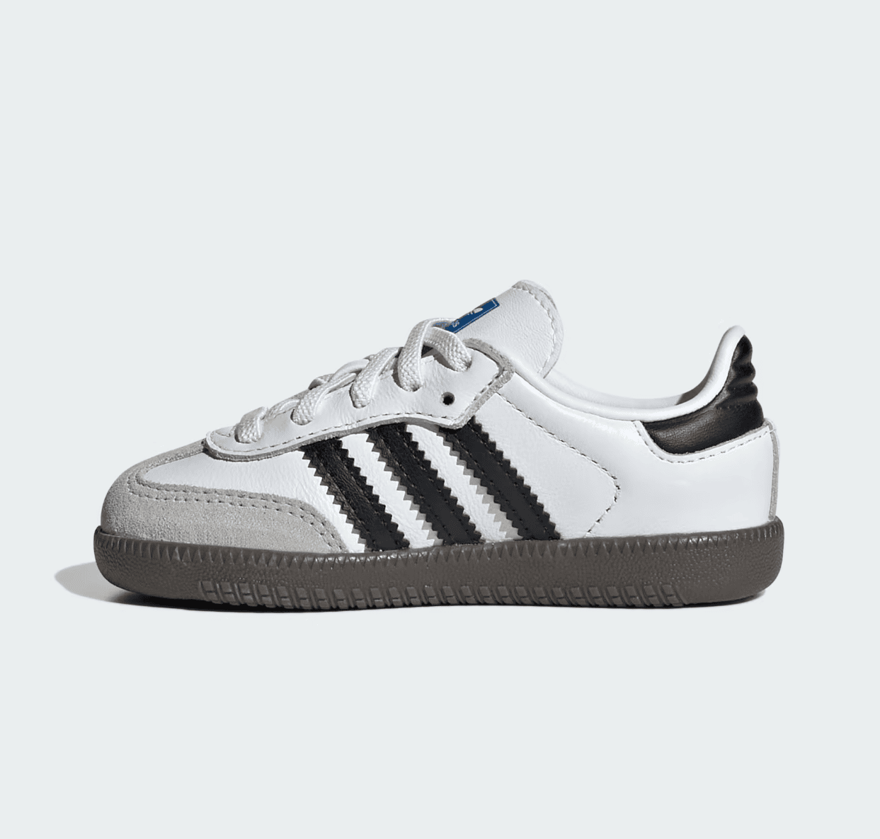 Screenshot_2025-02-10_201042 | AE JERSEY White low-top sneaker with black three stripes and gray suede toe cap on a brown sole (side view).