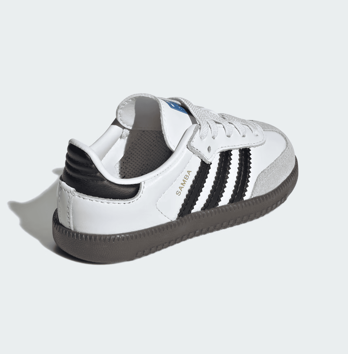 Screenshot_2025-02-10_201055 | AE JERSEY White Adidas Samba sneaker with black stripes and gray sole, shown at an angle to reveal side and toe details