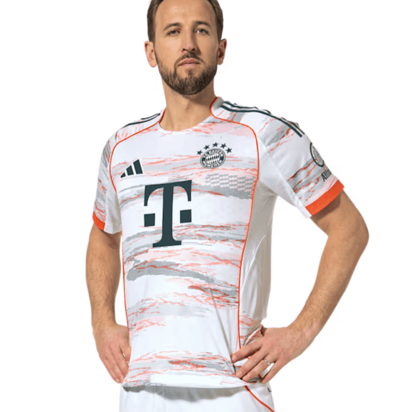 Man wearing a white Bayern Munich football jersey with orange trim, posing with hands on hips.