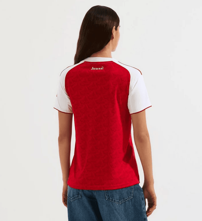 Screenshot_2025-06-25_051434 | AE JERSEY Rear view of a person wearing a red Arsenal football jersey with white sleeves.