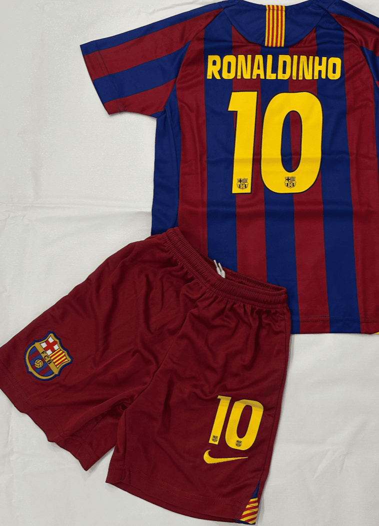 Screenshot_2025-07-21_185719 | AE JERSEY Barcelona soccer jersey with Ronaldinho 10 in yellow on a blue-and-maroon striped shirt, laid over maroon shorts with the club crest and a yellow 10.