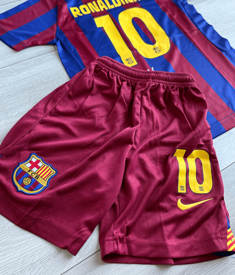 Screenshot_2025-07-21_185749 | AE JERSEY Barcelona FC maroon-and-blue jersey with the number 10 in yellow and name across the back, paired with matching maroon shorts featuring the club crest and a yellow Nike swoosh.
