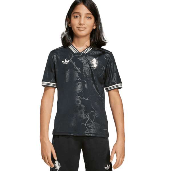 Girl wearing a black Adidas floral-pattern sports jersey and matching shorts, facing the camera.
