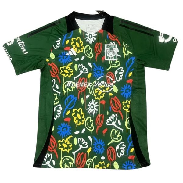 Green soccer jersey with a bold multicolored floral pattern on the front, black side panels, and a black collar; team crest on the left chest and sponsor text across the midsection, with green sleeves.