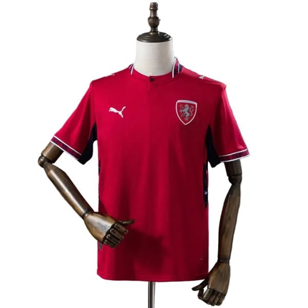 Red football jersey on a mannequin, displaying a white Puma logo and a Welsh national team crest on the chest.