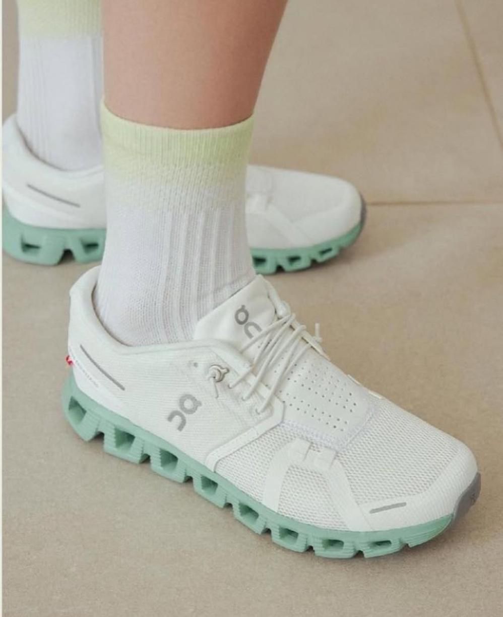 WhatsAppImage2025-01-26at09.34.17 | AE JERSEY White running sneaker with a mint-green sole worn with white socks, shown from the side on a tiled floor.
