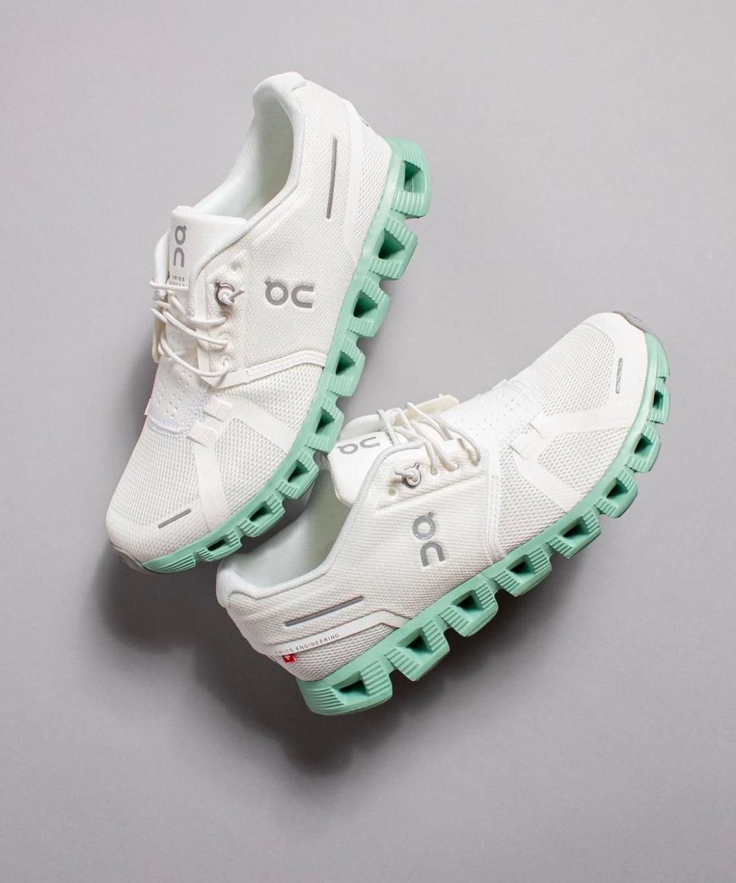 WhatsAppImage2025-01-26at09.34.38 | AE JERSEY White running shoes with mint-green segmented outsole and side logo visible on gray background.