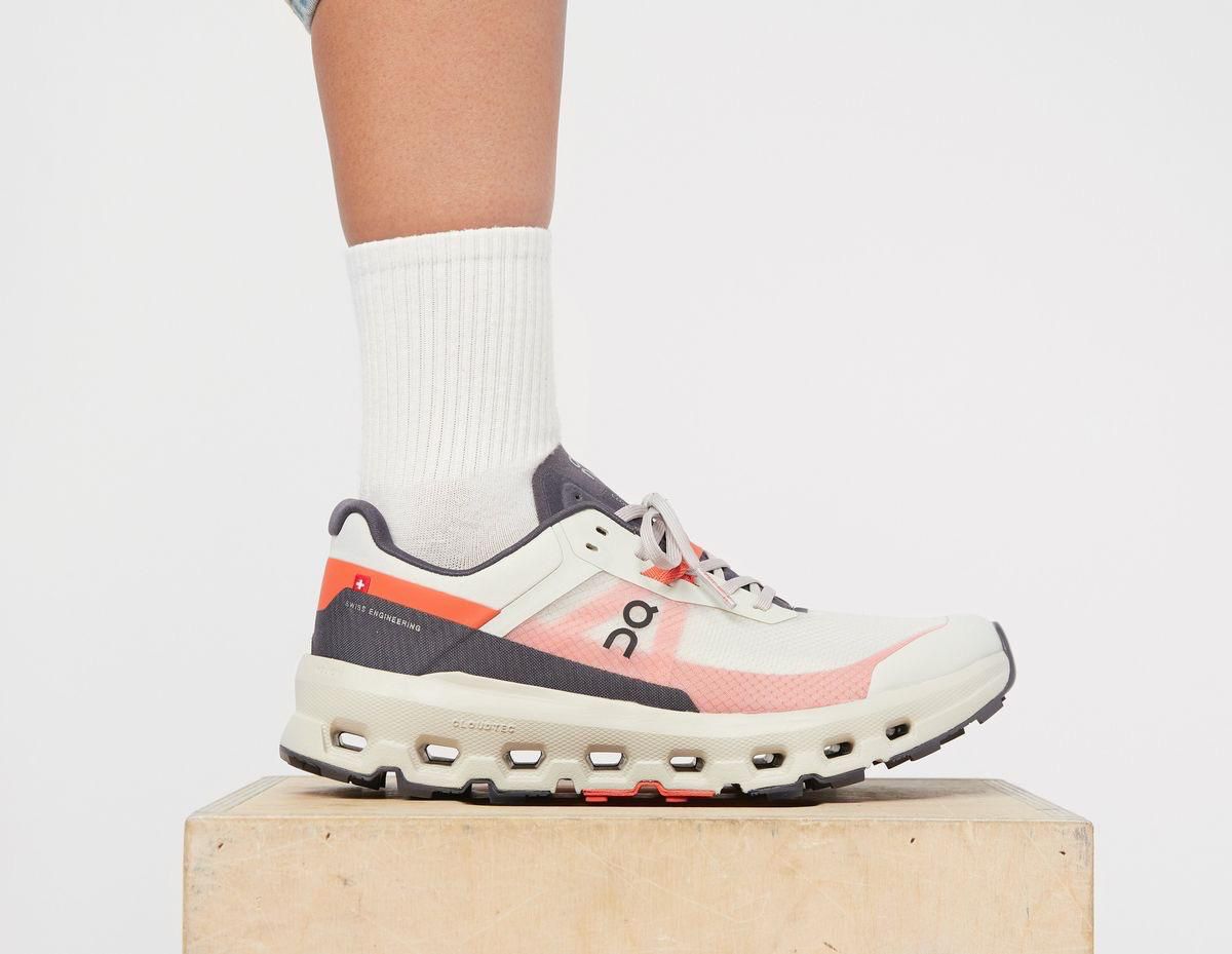 WhatsAppImage2025-02-21at13.47.27 | AE JERSEY White and pink On running shoe on a wooden block, worn with a white crew sock.