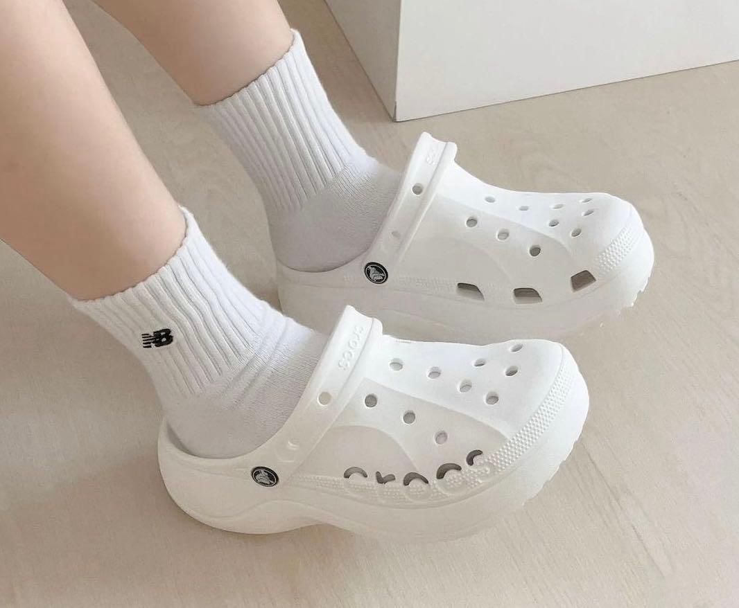 WhatsApp_Image_2024-10-19_at_11.33.55 | AE JERSEY Person wearing white Crocs with white socks indoors on a light floor.