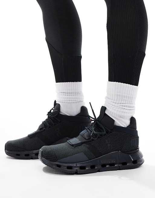 WhatsApp_Image_2024-11-06_at_11.22.24 | AE JERSEY Close-up of black athletic sneakers with white crew socks on feet, lifestyle product shot