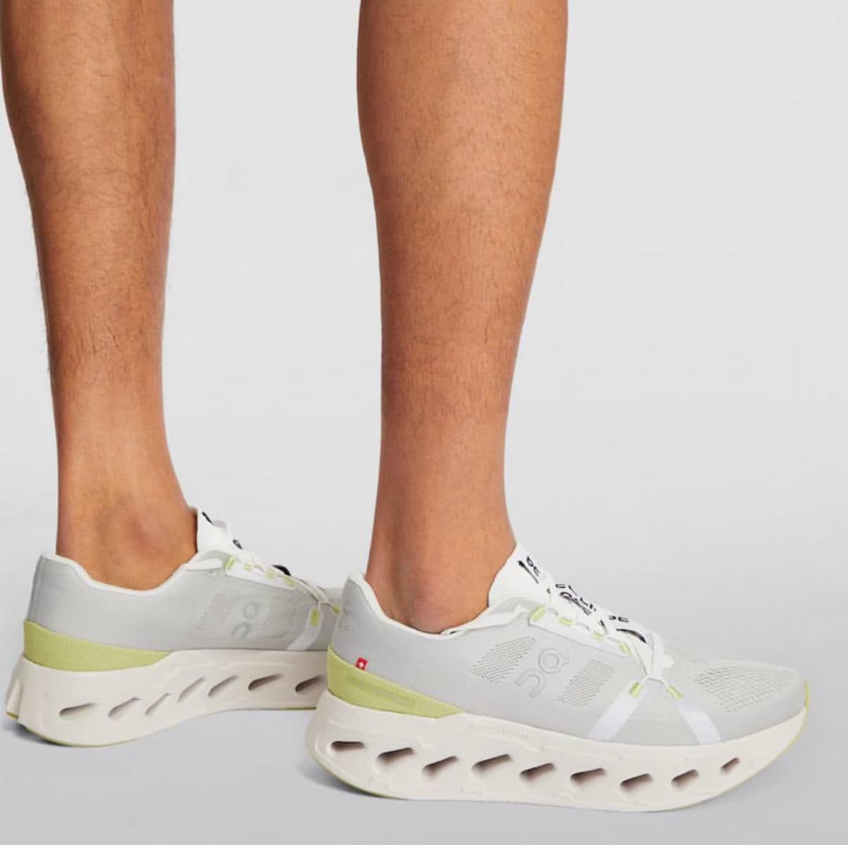 WhatsApp_Image_2025-01-18_at_13.18.07 | AE JERSEY White and light gray running sneakers with lime accents and a hollow-cut sole worn on feet