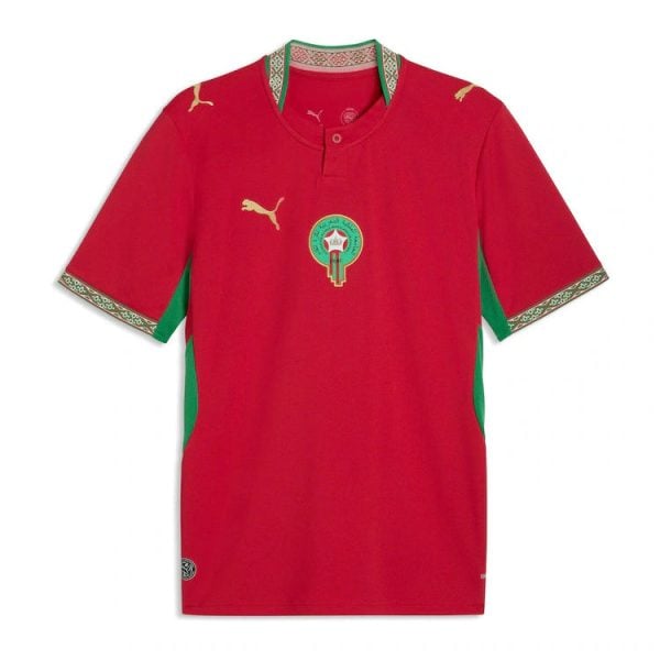 Red soccer jersey with green side panels, gold Puma logos, and a circular team crest on the chest (front view).