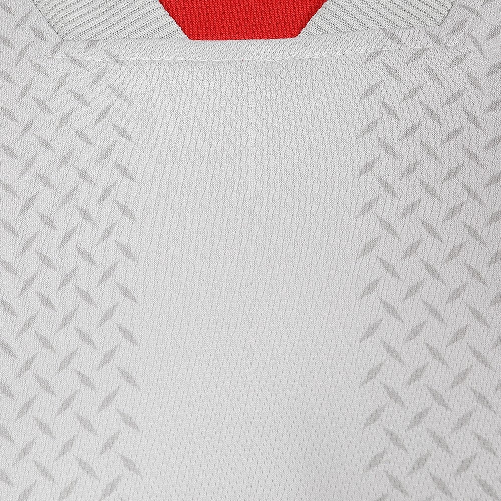 ZKNZJJ0BStrjfRI_8cd3b76d-424e-47af-8141-6bd70bd3f25a | AE JERSEY Close-up of white textured fabric with a red neckline, suggesting a sports jersey