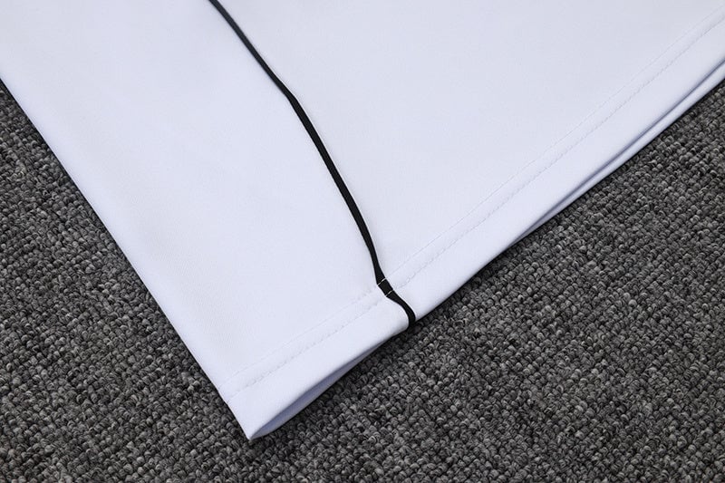 a53cb506 | AE JERSEY Close-up of pale lavender fabric with a black zipper seam along the edge on a gray carpeted surface