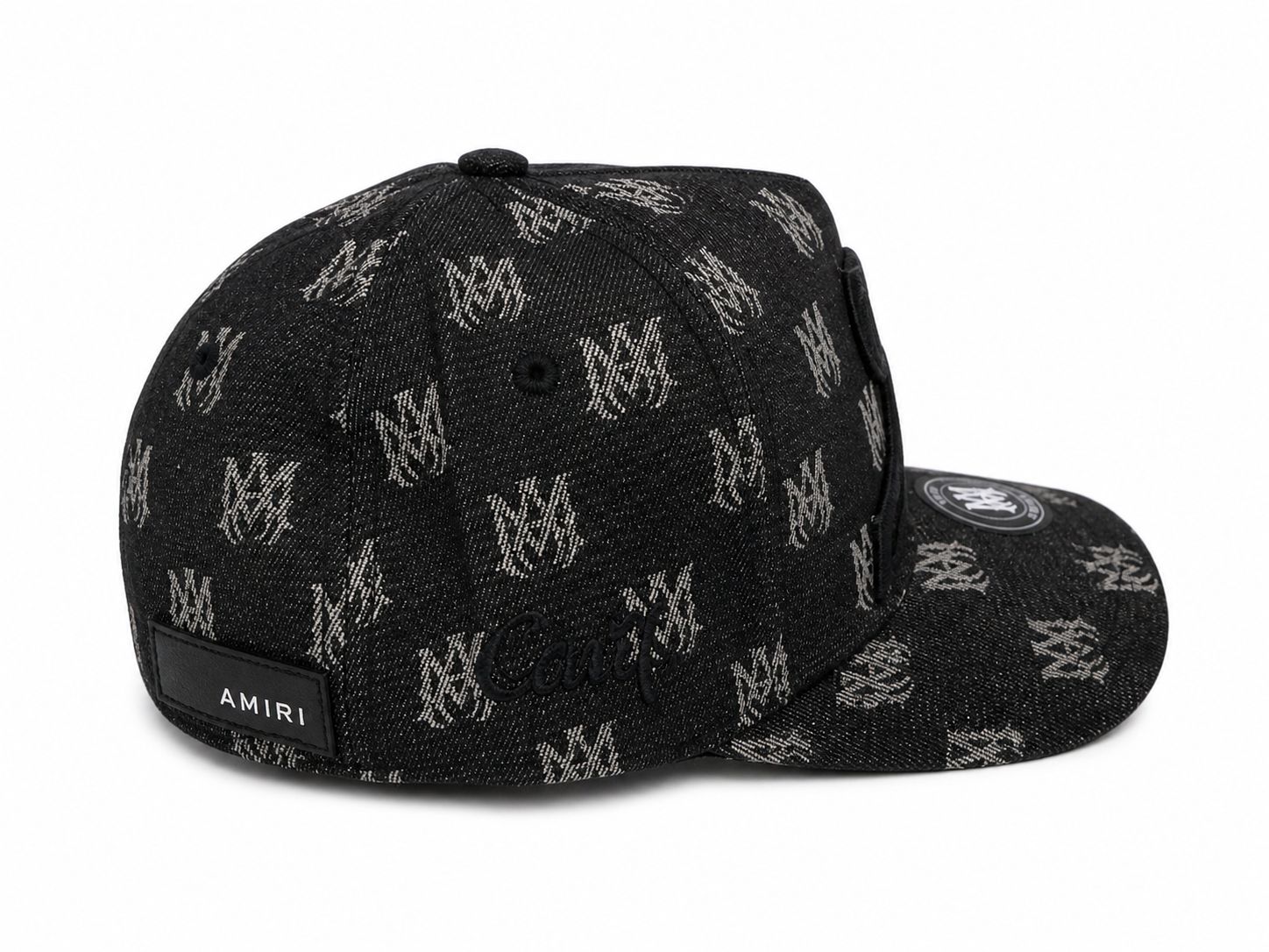 a6714065-e29f-4c89-9879-ecd6889720af | AE JERSEY Black denim cap with a repeating white logo pattern and an Amiri label on the back, curved brim with a circular patch on the top.