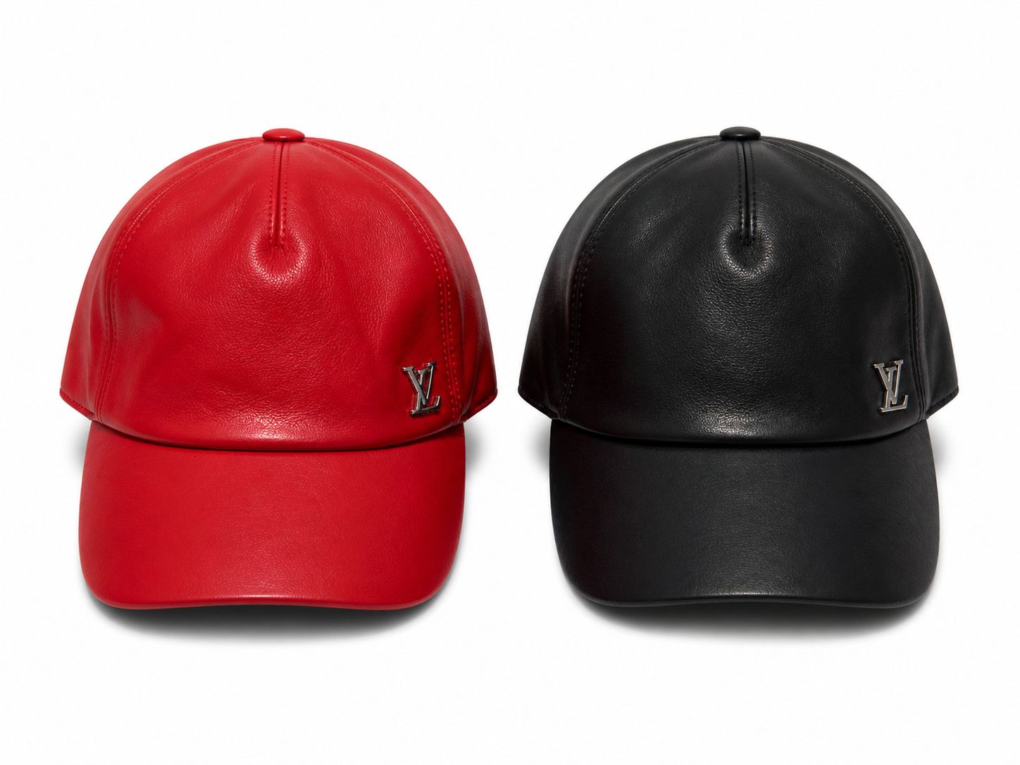 a6fdf30d-4911-457a-b012-333c18143a59 | AE JERSEY Two leather baseball caps, one red and one black, with silver LV logos on the front panels.