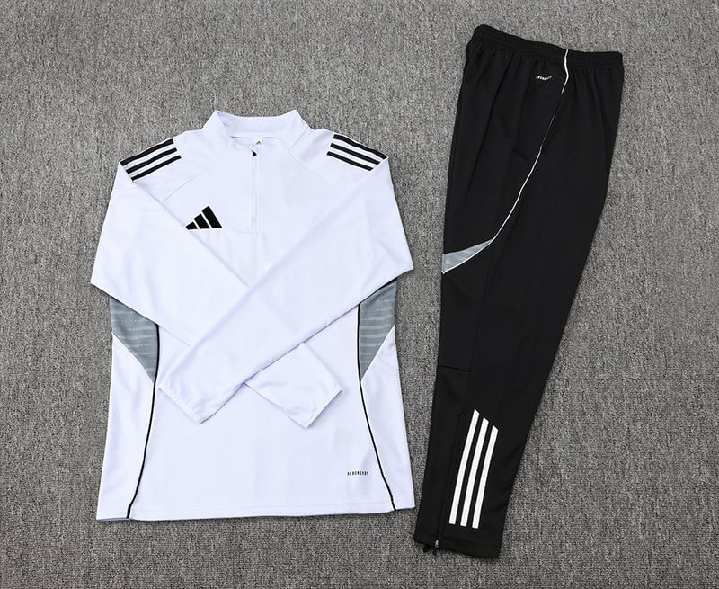 b4992401 | AE JERSEY White Adidas training top with black shoulder stripes and gray side panels, laid next to black track pants with white stripes.