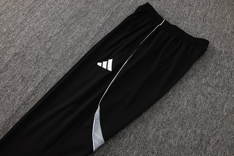 b4d7f4d2 | AE JERSEY Black athletic joggers with white piping and a small Adidas logo on the thigh, laid flat on gray carpet