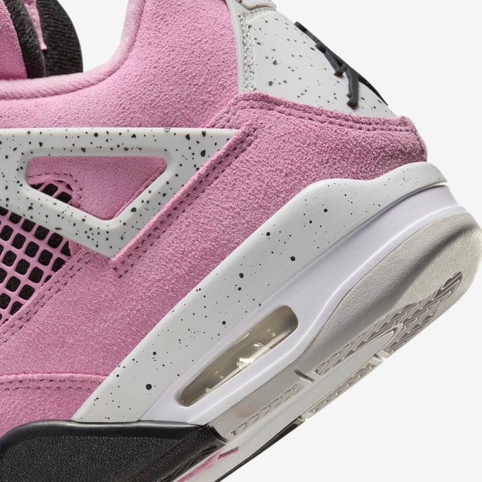 b5df8d94_c49e_48f6_b4ab_32c1970cccdf | AE JERSEY Close-up of a pink suede sneaker heel with a white speckled midsole and visible air cushioning window.