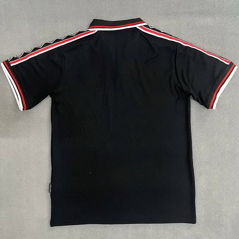 b64a26f29ecb0728 | AE JERSEY Back view of a black polo shirt with red and white racing stripes along the shoulders and sleeve edges.