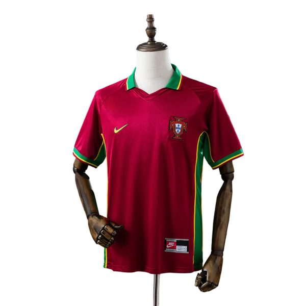Portugal national soccer jersey in maroon with green-yellow trim on collar and sides, displayed on a mannequin with crest on chest