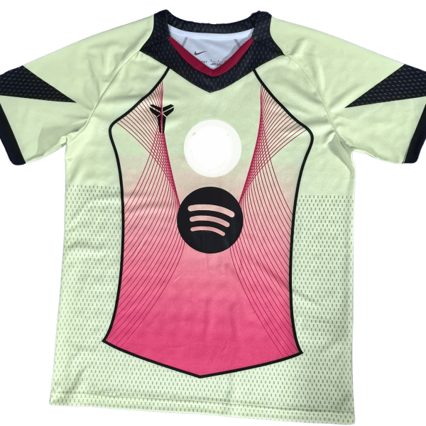 Front view of a lime-green athletic jersey with pink center panel, black trim, and a circular dark logo on the chest.