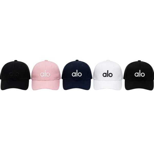 Row of five baseball caps in black, pink, navy, white, and black, each with the 'alo' logo on the front.