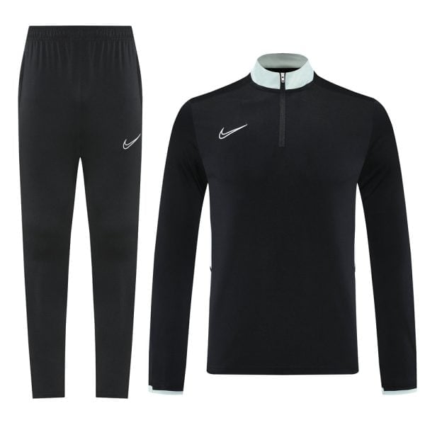 Black Nike tracksuit: long-sleeve pullover with light blue collar trim and half-zip, matching black jogger pants with a white swoosh.