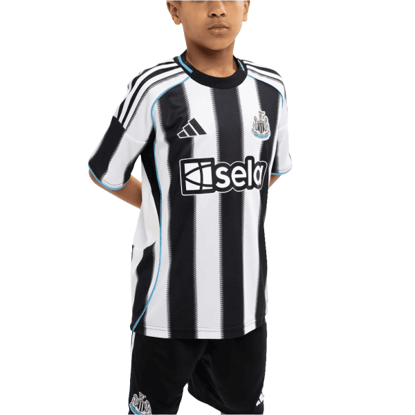 Young boy wearing a black-and-white striped soccer jersey with blue trim and sponsor logo, posing with hands behind back.