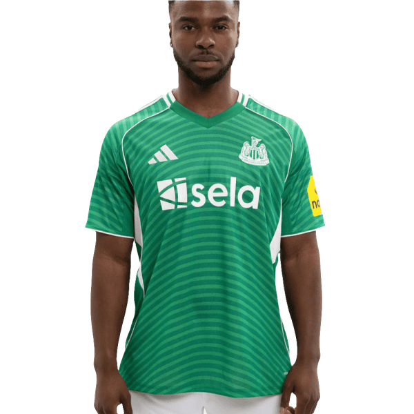 Man wearing a green soccer jersey with white sponsor logo 'sela' and team crest on the chest, facing forward.