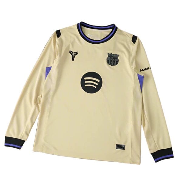 Beige football jersey with blue-purple trim featuring a Spotify logo circle and wavy lines on the chest, Barca crest on the left, and small logos on the chest and cuffs.