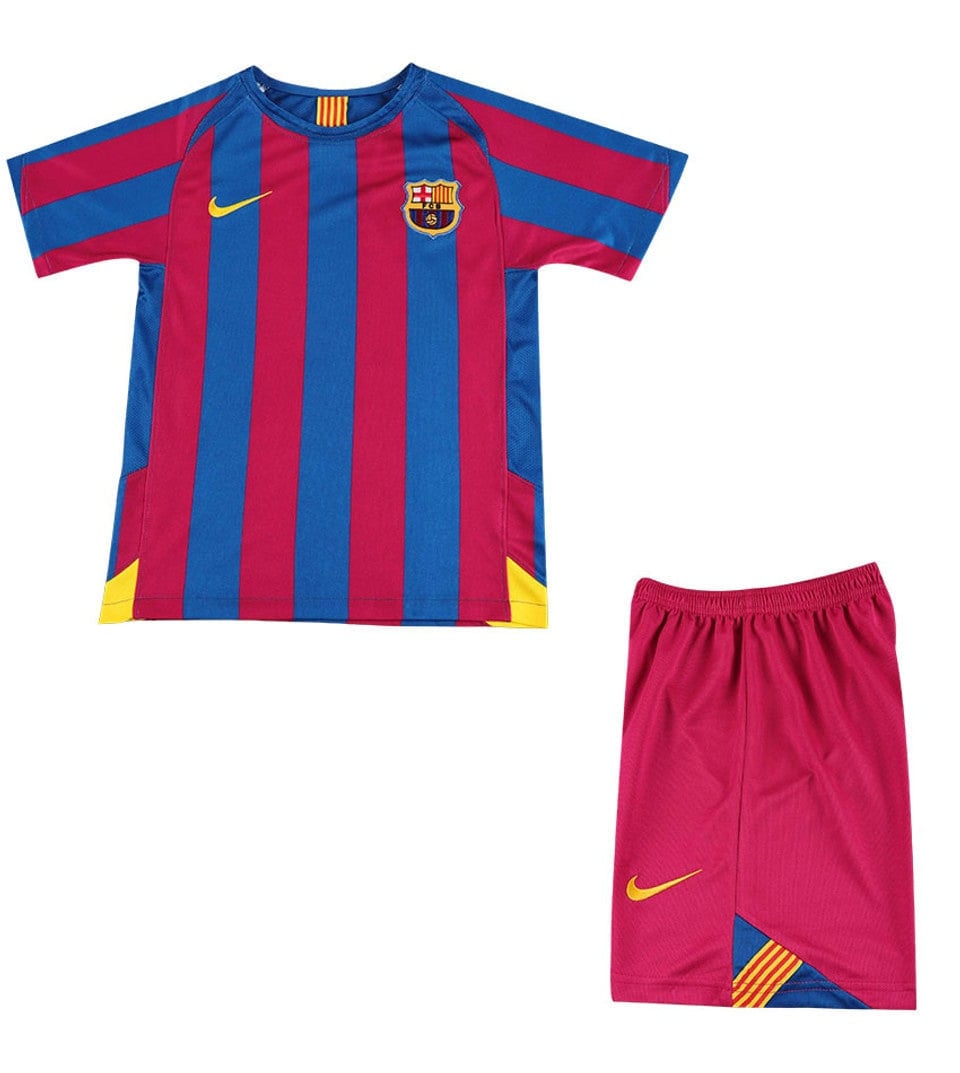 barca0506__66341 | AE JERSEY Barcelona football kit: blue and maroon striped jersey with crest and yellow Nike logo, paired with pink shorts featuring a yellow swoosh and color-blocked corner detail.