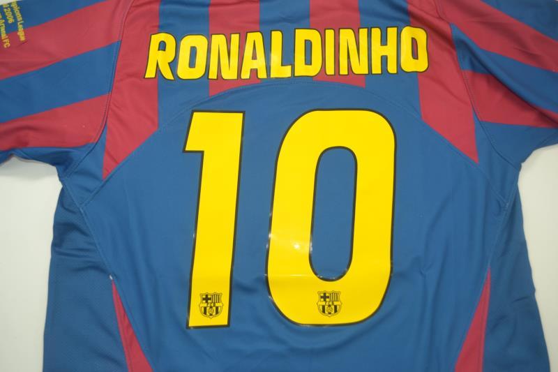 barcelona-classic-home-final-2006-140114_4e4c99d1-22cd-40c5-a58d-50a747b9d2fa | AE JERSEY Barcelona football jersey with 'RONALDINHO' and a large yellow number 10 on blue and maroon stripes, plus small crests.