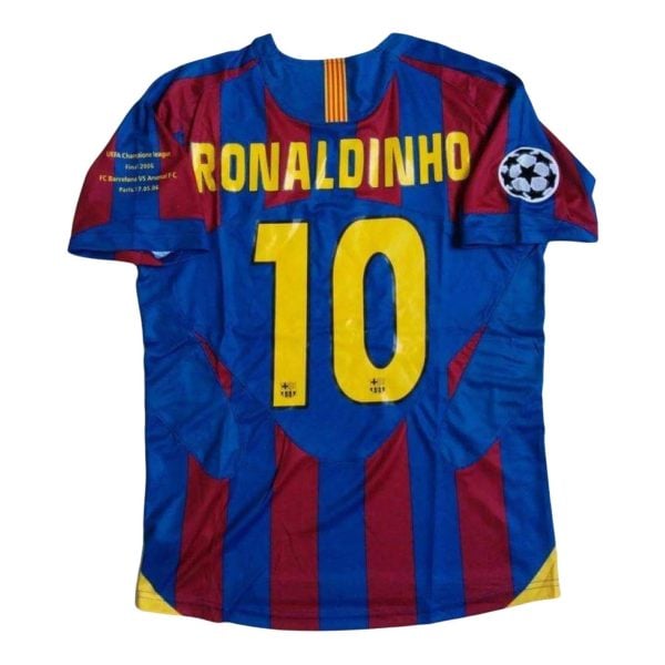 Barcelona football jersey with 'RONALDINHO' and number 10 on the back, features blue and maroon stripes and a UEFA Champions League patch on the sleeve