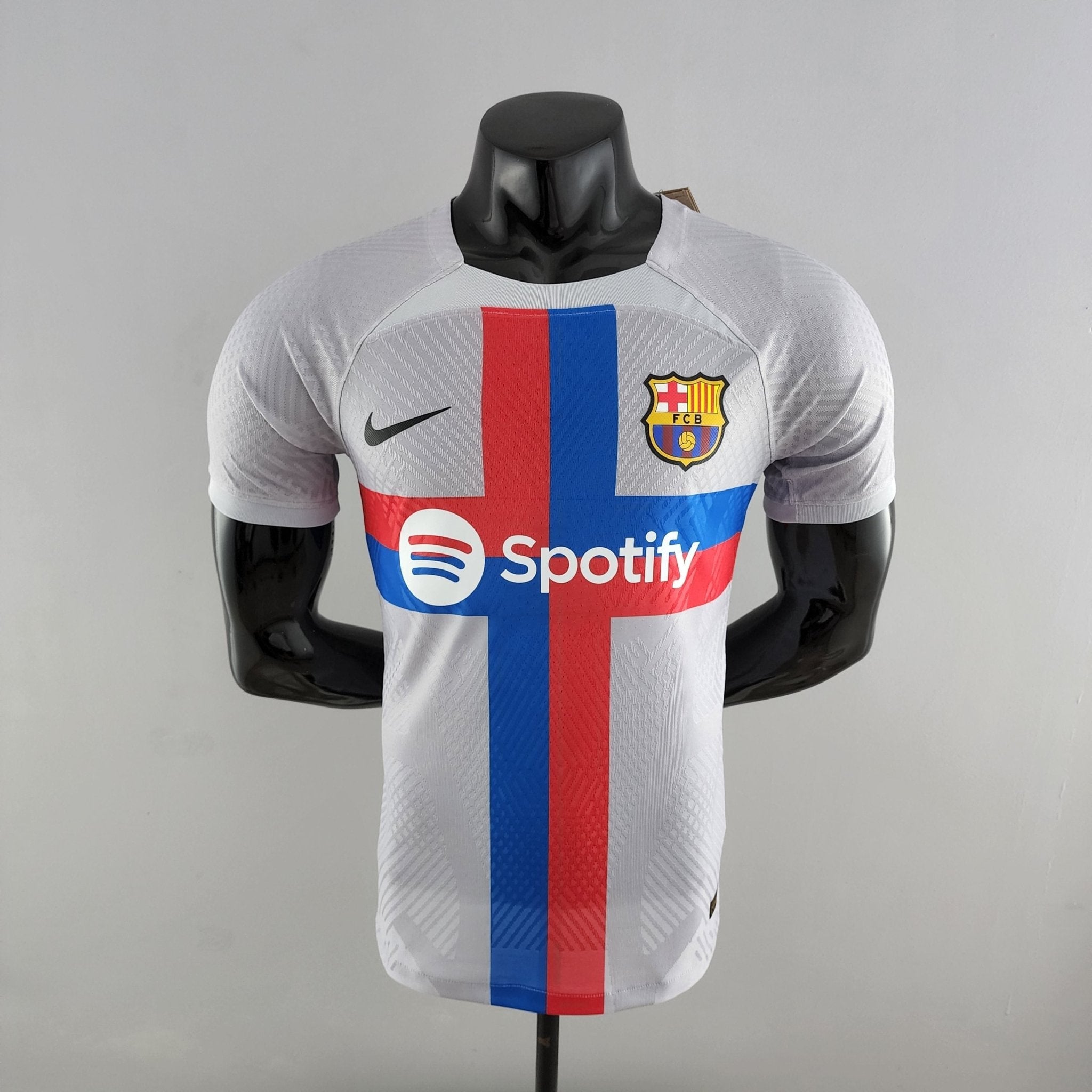 barcelona-third-player-version-jersey-202223-357734 | AE JERSEY FC Barcelona jersey on a mannequin with a red-blue vertical stripe and Spotify logo on the front.