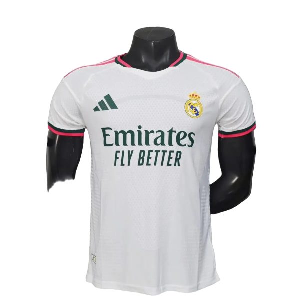 White Real Madrid soccer jersey on a mannequin, with Emirates Fly Better sponsor and club crest on chest.