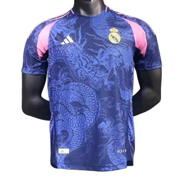 Blue Real Madrid football jersey with a dragon pattern, pink shoulder panels, Adidas logo, and team crest on the chest.