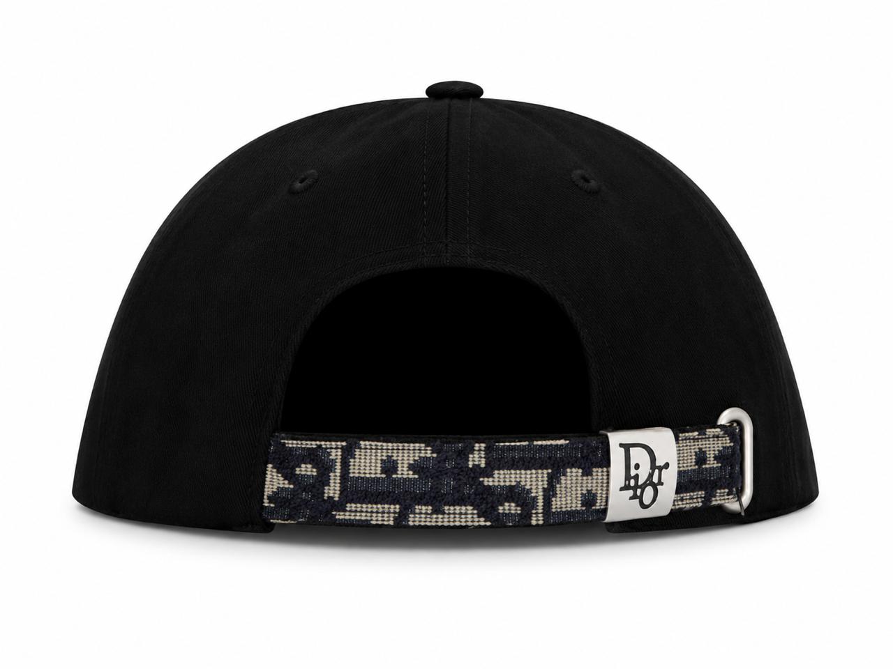 d15d32d4-7d14-46dc-90c8-83de926f9ff1 | AE JERSEY Back view of a black baseball cap with an adjustable camo strap and silver buckle.