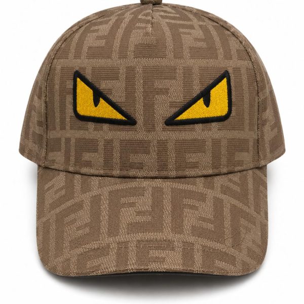 Brown patterned baseball cap with a bold yellow angry-eye patch on the front panel for a playful, edgy look.