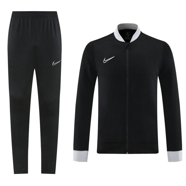 Black Nike tracksuit set: full-zip jacket with grey cuffs and collar, paired with black jogger pants showing a white Nike swoosh.