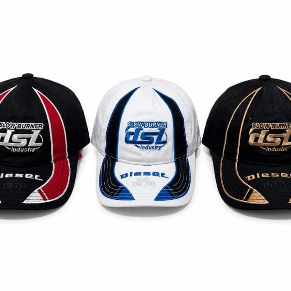 Row of three baseball caps: left black with red and white piping, center white with blue accents, right black with gold piping, all featuring Diesel branding and '1978' text.