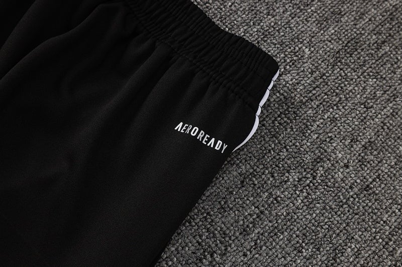 d8b38d15 | AE JERSEY Close-up of black athletic shorts with an elastic waistband and the 'AEROREADY' logo on a gray carpet.
