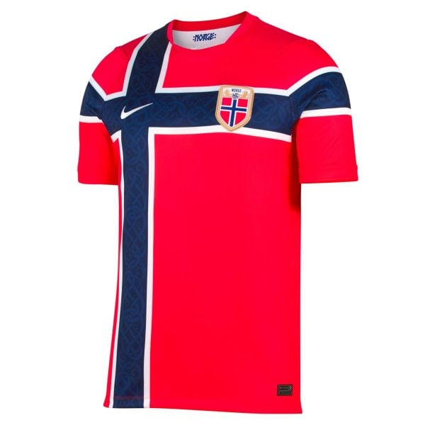 Front view of a red Norway national team soccer jersey with a blue patterned sash, white trim, and crest on the chest.