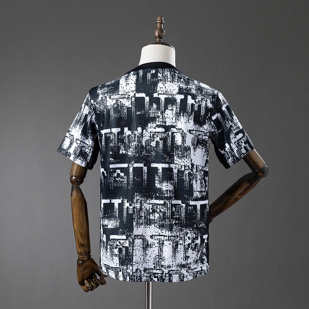 e34a75a7-1 | AE JERSEY Back view of a short-sleeve black-and-white abstract print T-shirt on a dress form, displayed mannequin style.